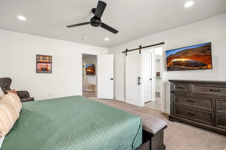 Spacious room featuring white walls and neutral carpet