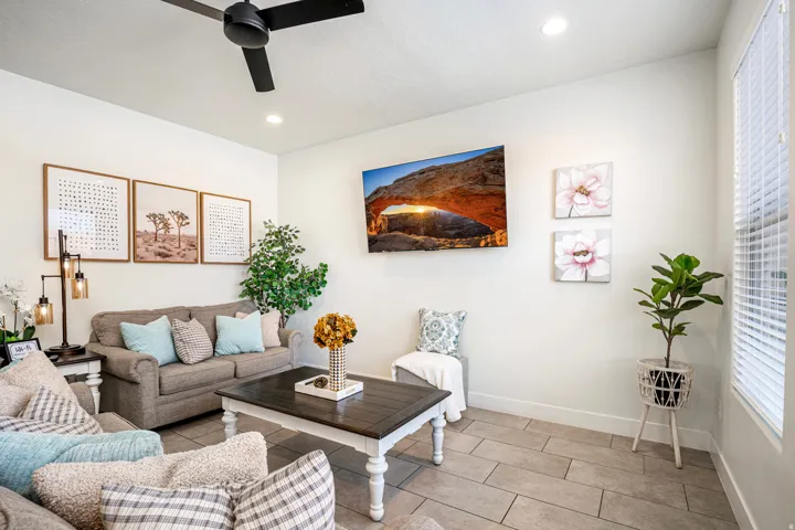 Living area featuring tile flooring, recessed lighting, a ceiling fan, and window blinds