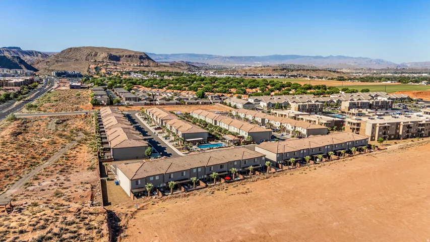 Townhome community featuring neutral-toned exteriors and tile roofs