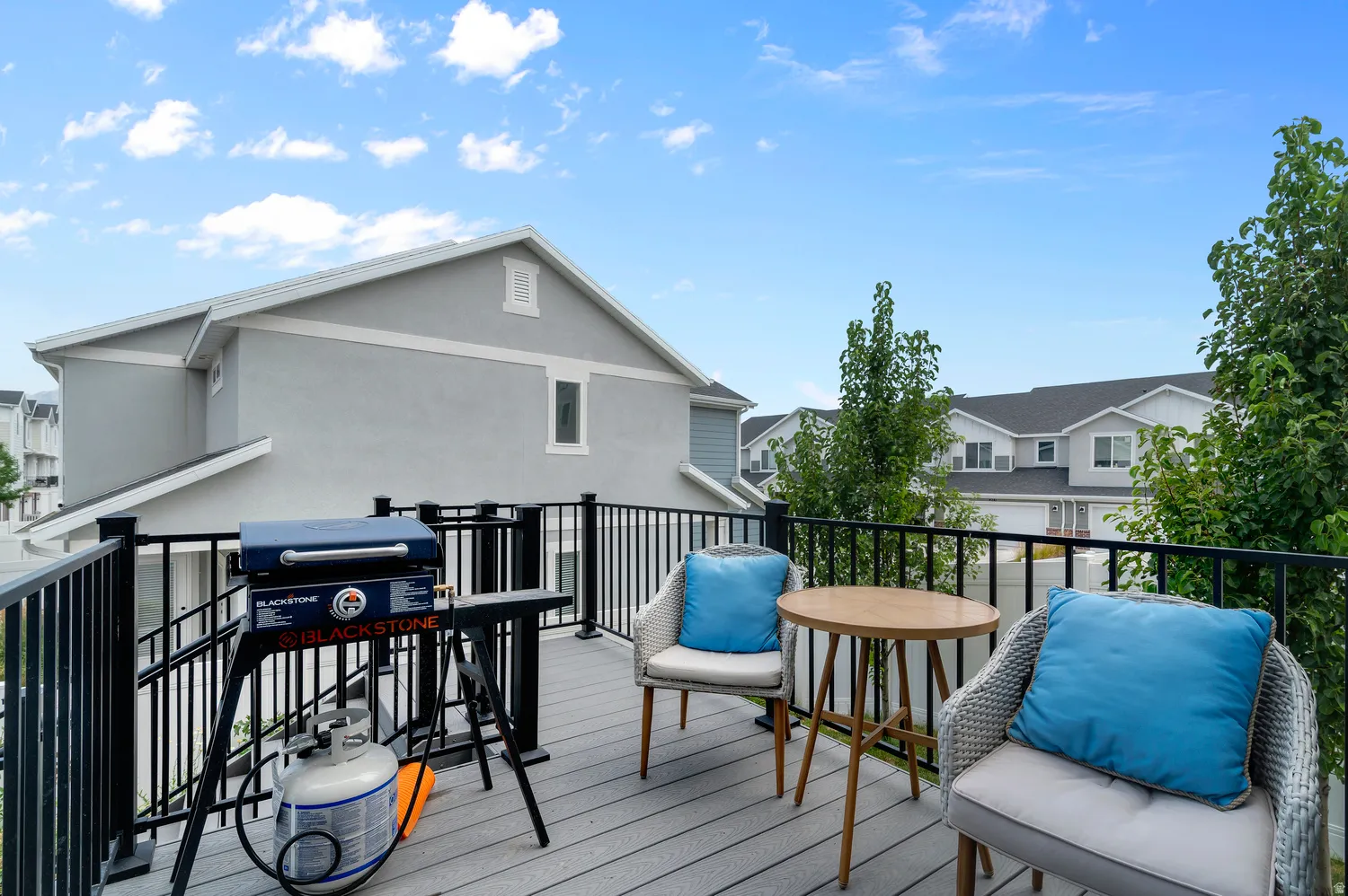 Upper-level deck featuring composite decking and black metal railings
