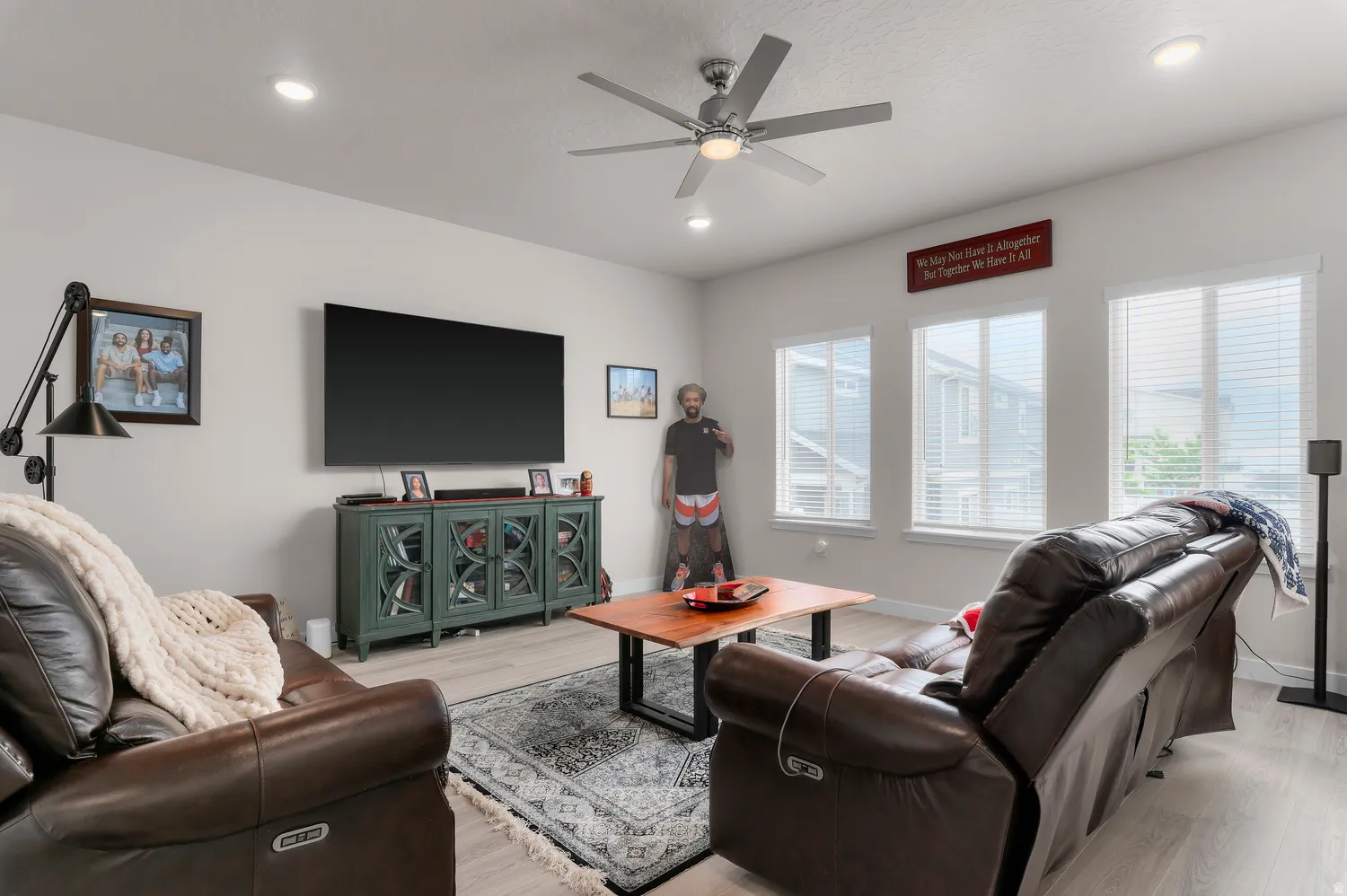 Living area featuring light wood-finish flooring, recessed lighting, and a ceiling fan