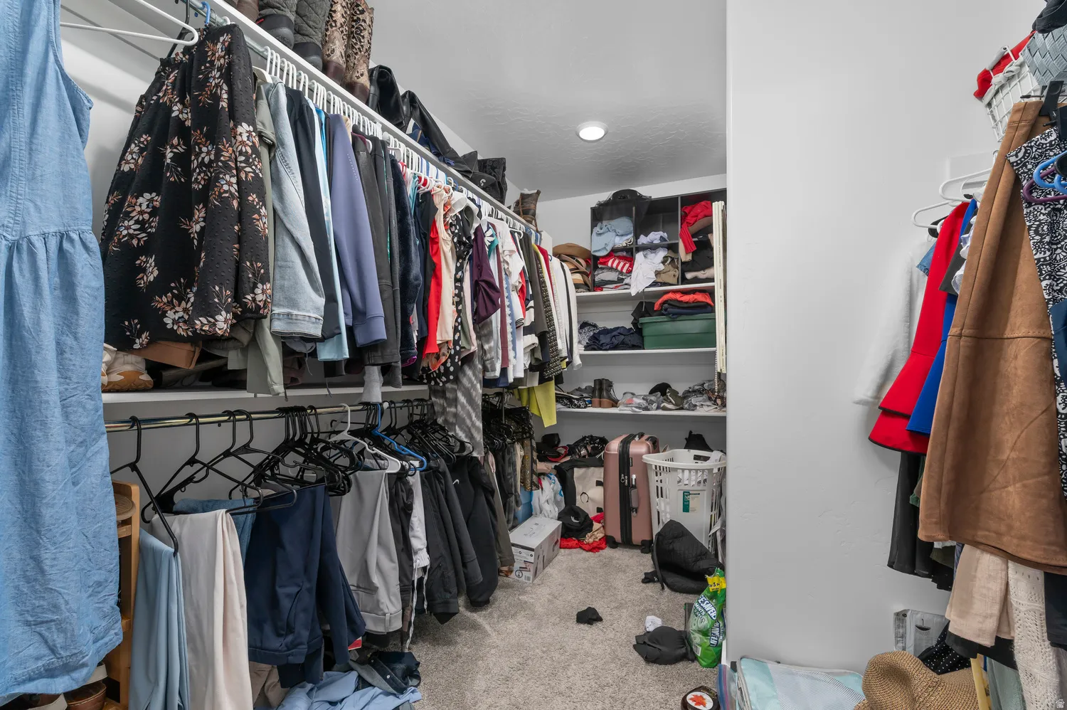 Built-in closet system featuring multiple hanging rods and shelving