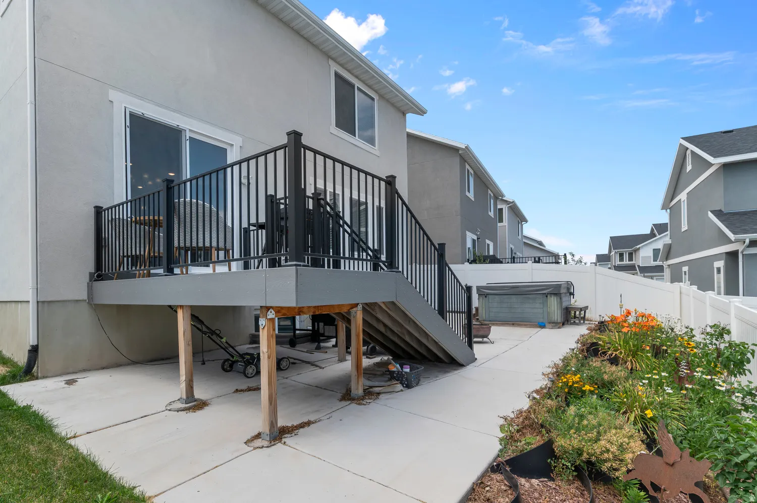Rear deck with dark railings and a sliding glass door