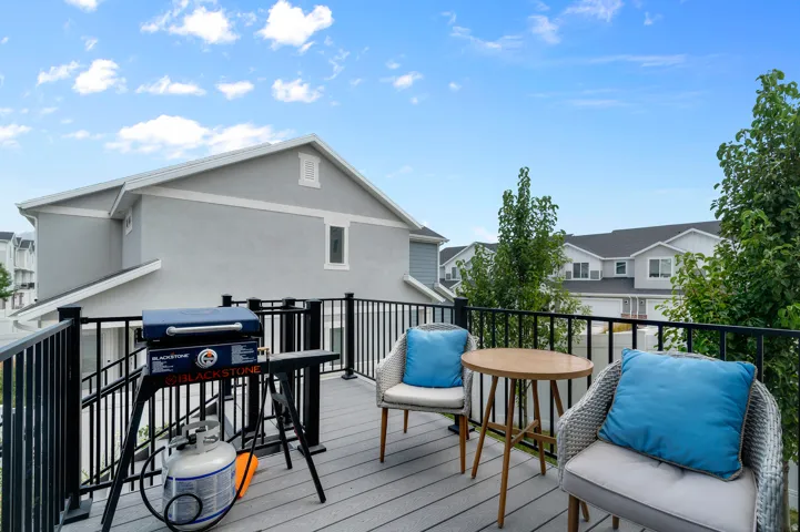Upper-level deck featuring composite decking and black metal railings