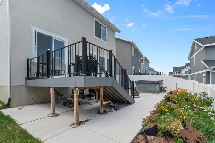 Rear deck with dark railings and a sliding glass door