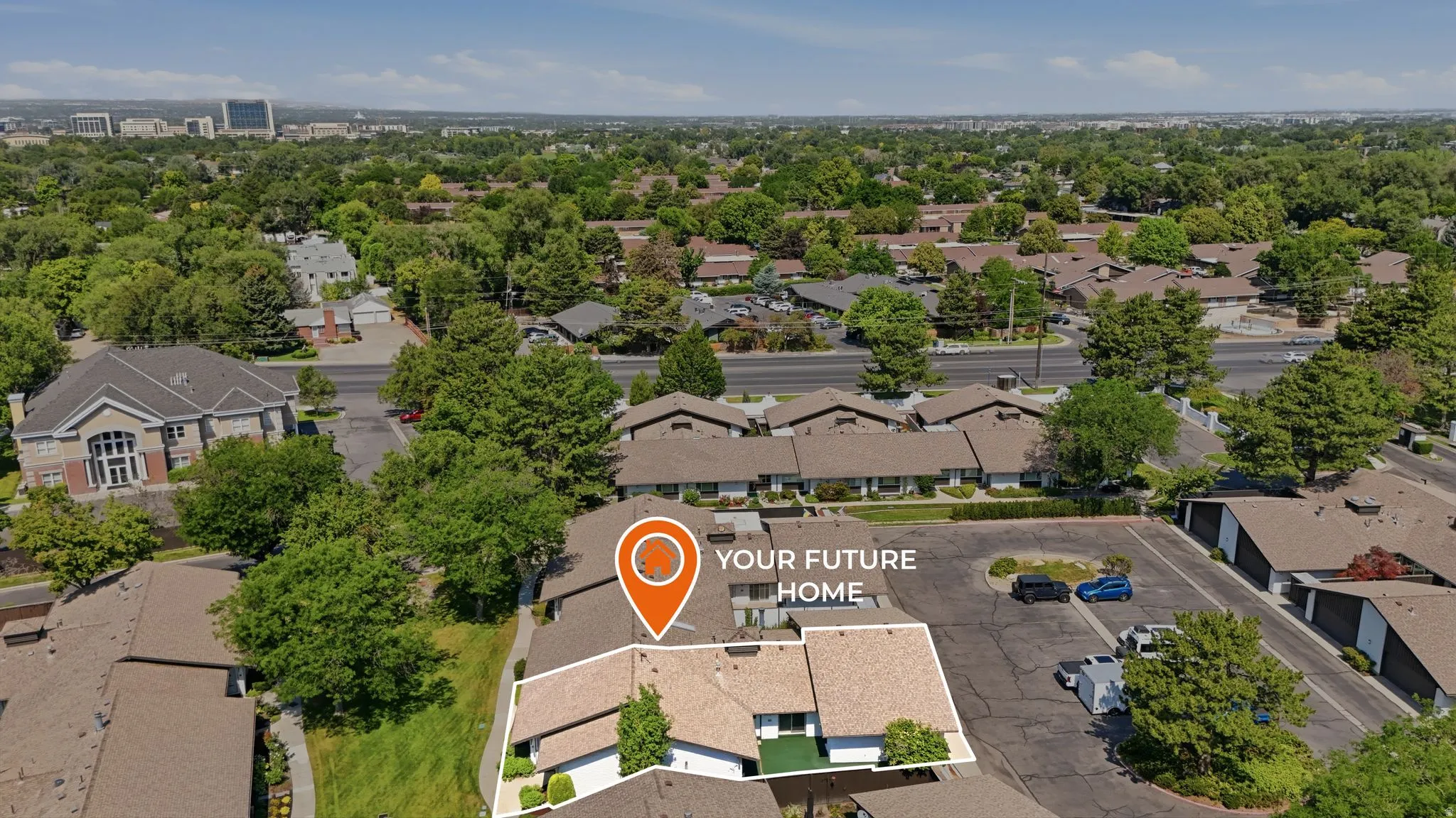 Aerial view showcasing a residential property within a green, tree-lined neighborhood