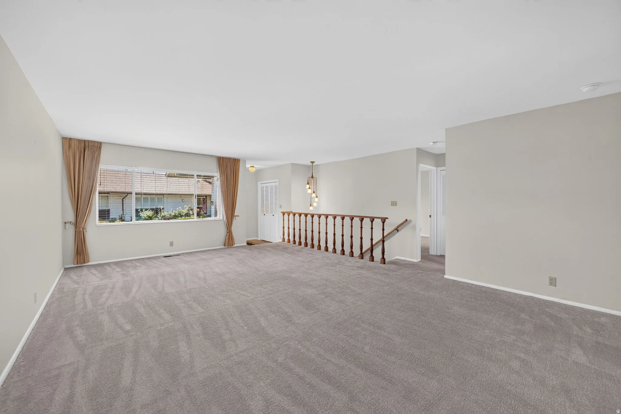 Spacious interior with neutral gray carpeting and light-toned wall finishes