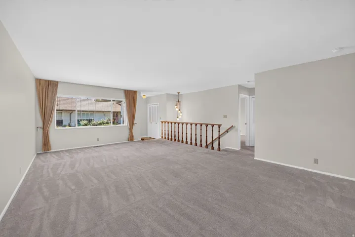 Spacious interior with neutral gray carpeting and light-toned wall finishes