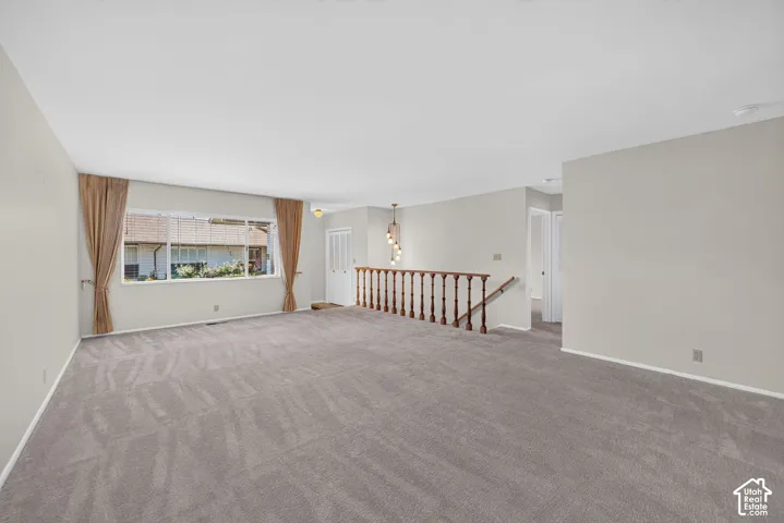 Spacious interior with neutral gray carpeting and light-toned wall finishes