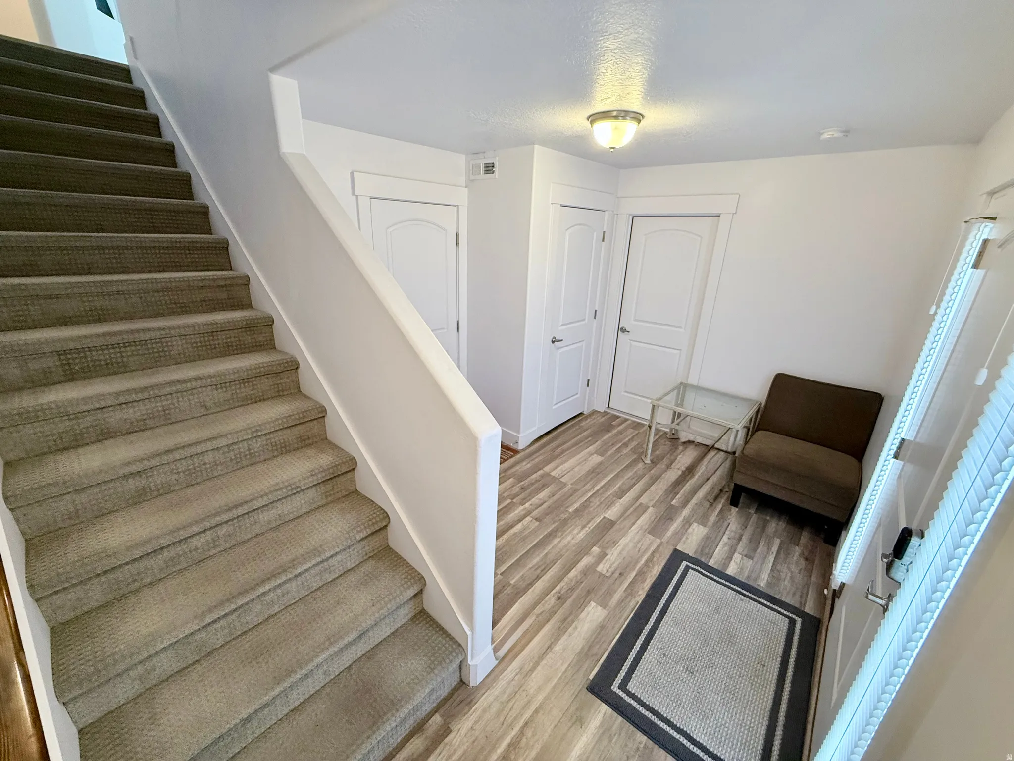 Foyer and entry way from both the garage and front door. Stairs to 2nd level. Mechanical room and storage/coat closet are located here in the foyer.