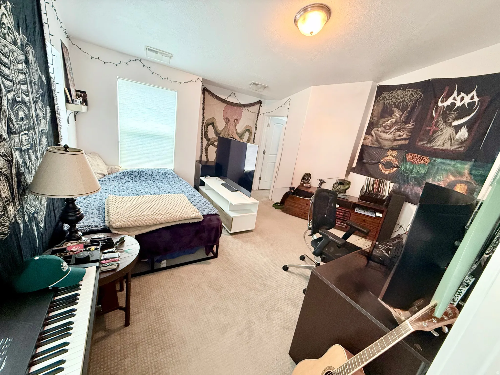 Carpeted room featuring sloped ceilings and a flush-mount light fixture