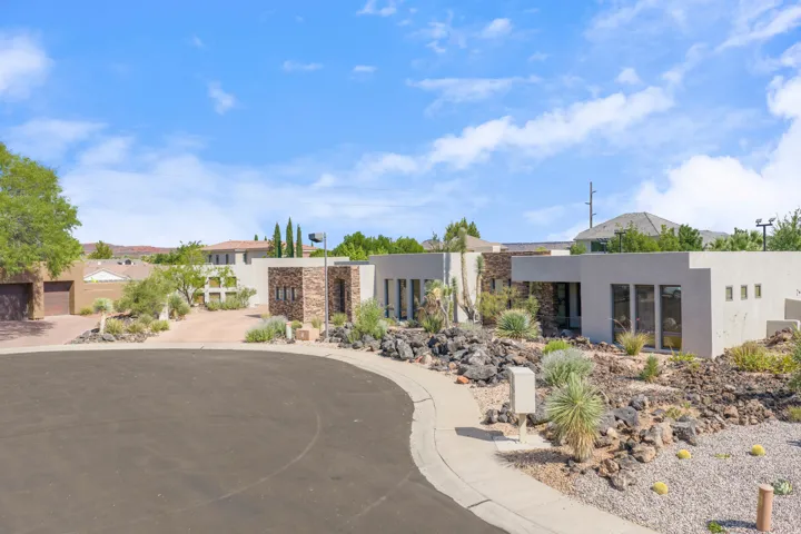 Contemporary desert landscaping featuring varied rock elements and mature drought-tolerant plantings