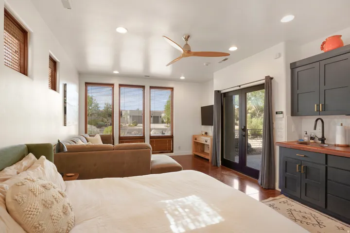 Open-concept living space featuring wood-finish flooring, recessed lighting, and a ceiling fan