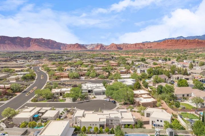 Expansive residential community with diverse architectural styles, featuring mature landscaping and paved roads