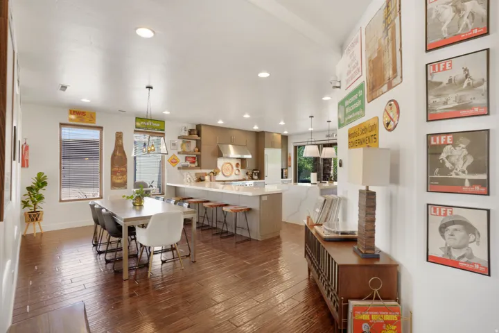 Open-concept kitchen and dining area with rich wood-finish flooring