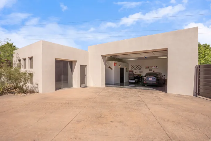 Modern architecture featuring a smooth stucco exterior and an integrated garage