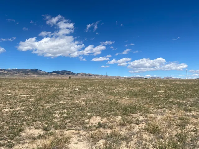 Expansive undeveloped land with a distant mountain range backdrop