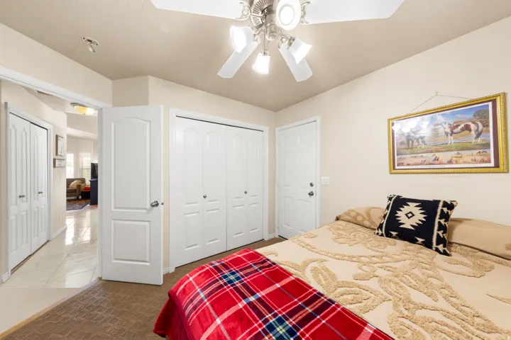 Recessed lighting, ceiling fan with light fixture, double bifold closet doors, and a paneled door