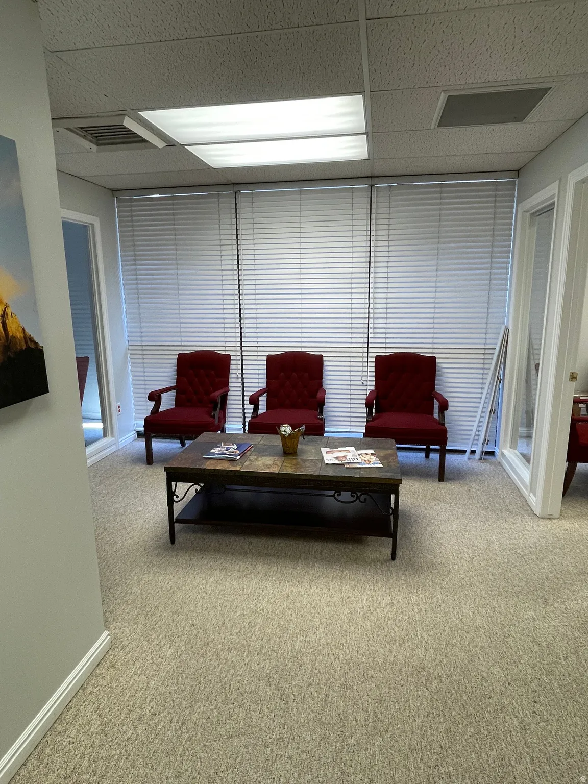 Carpeted room with recessed lighting and drop ceiling