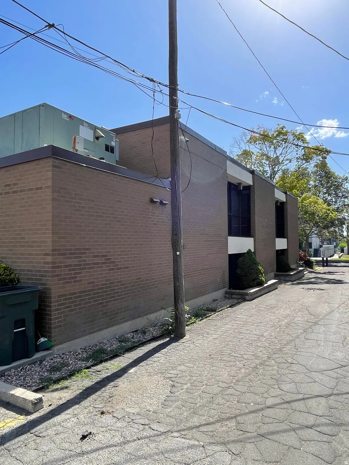 Brick exterior building featuring black-framed windows and a flat roofline