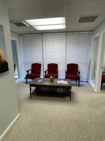 Carpeted room with recessed lighting and drop ceiling