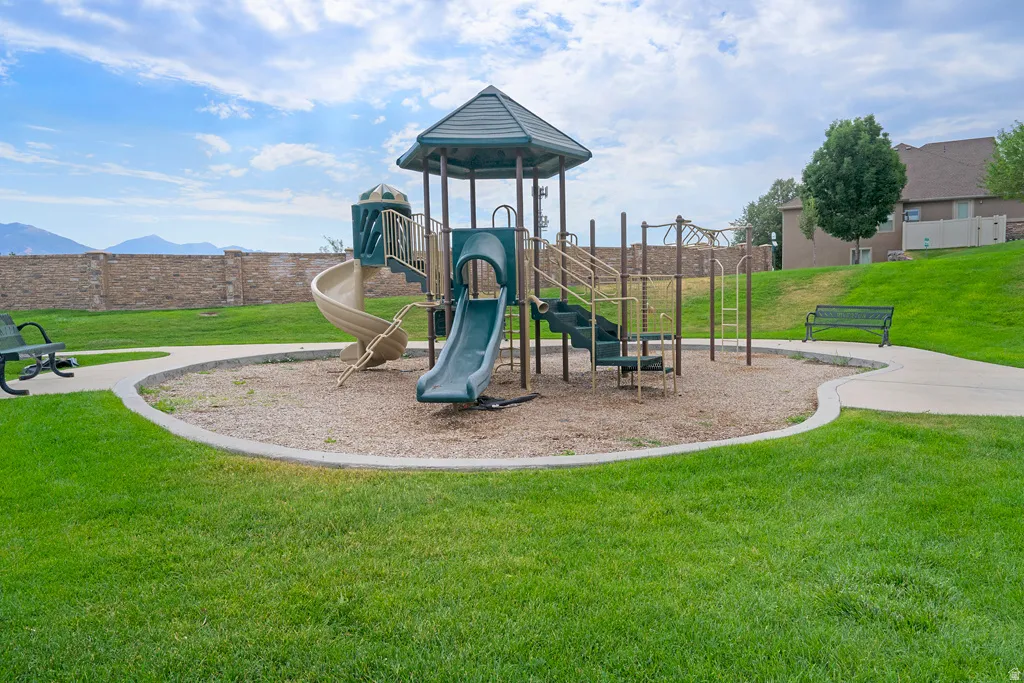 Community playground featuring slides, climbing structures, and benches