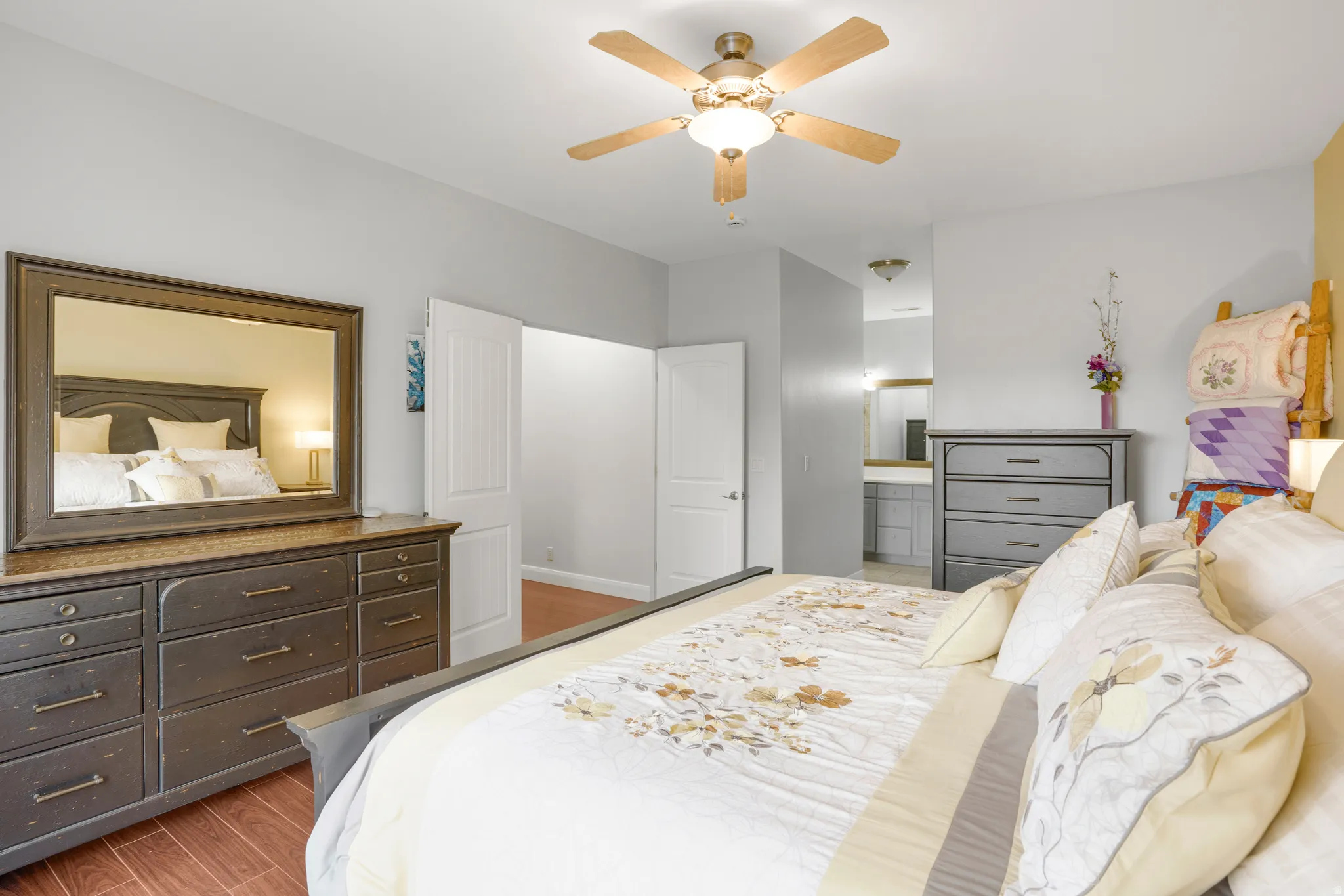 Hardwood-style flooring extends through the room, complemented by light gray walls