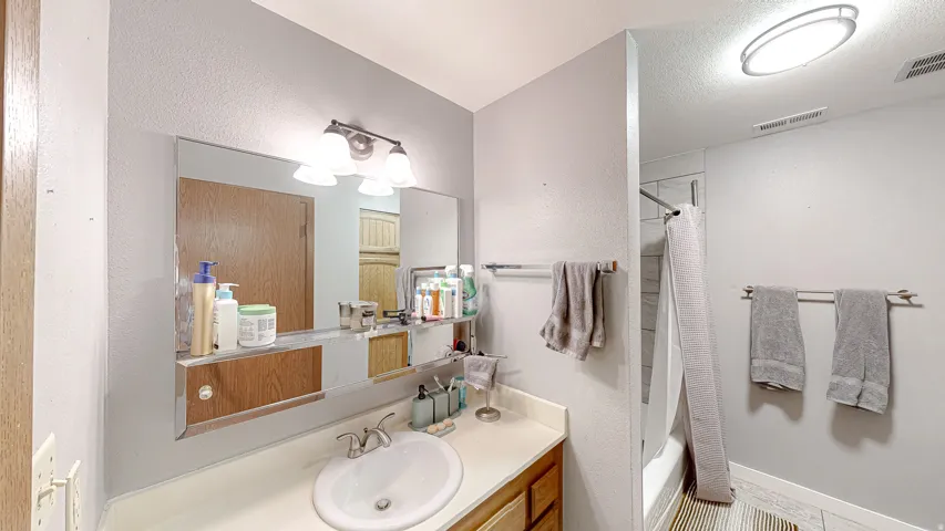 Bathroom featuring a vanity with a white countertop and a built-in sink
