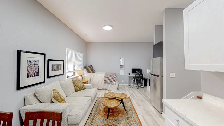 Open concept living area featuring light wood-finish flooring and neutral wall tones