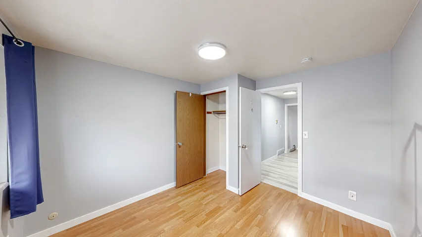 Room featuring wood-finish flooring and light gray walls
