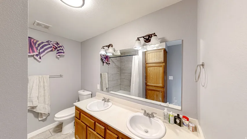 Double vanity with undermount sinks and wood-finish cabinetry