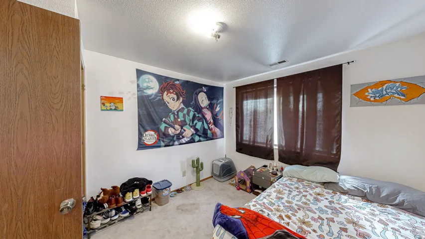 Bedroom with light-toned walls and carpeted flooring