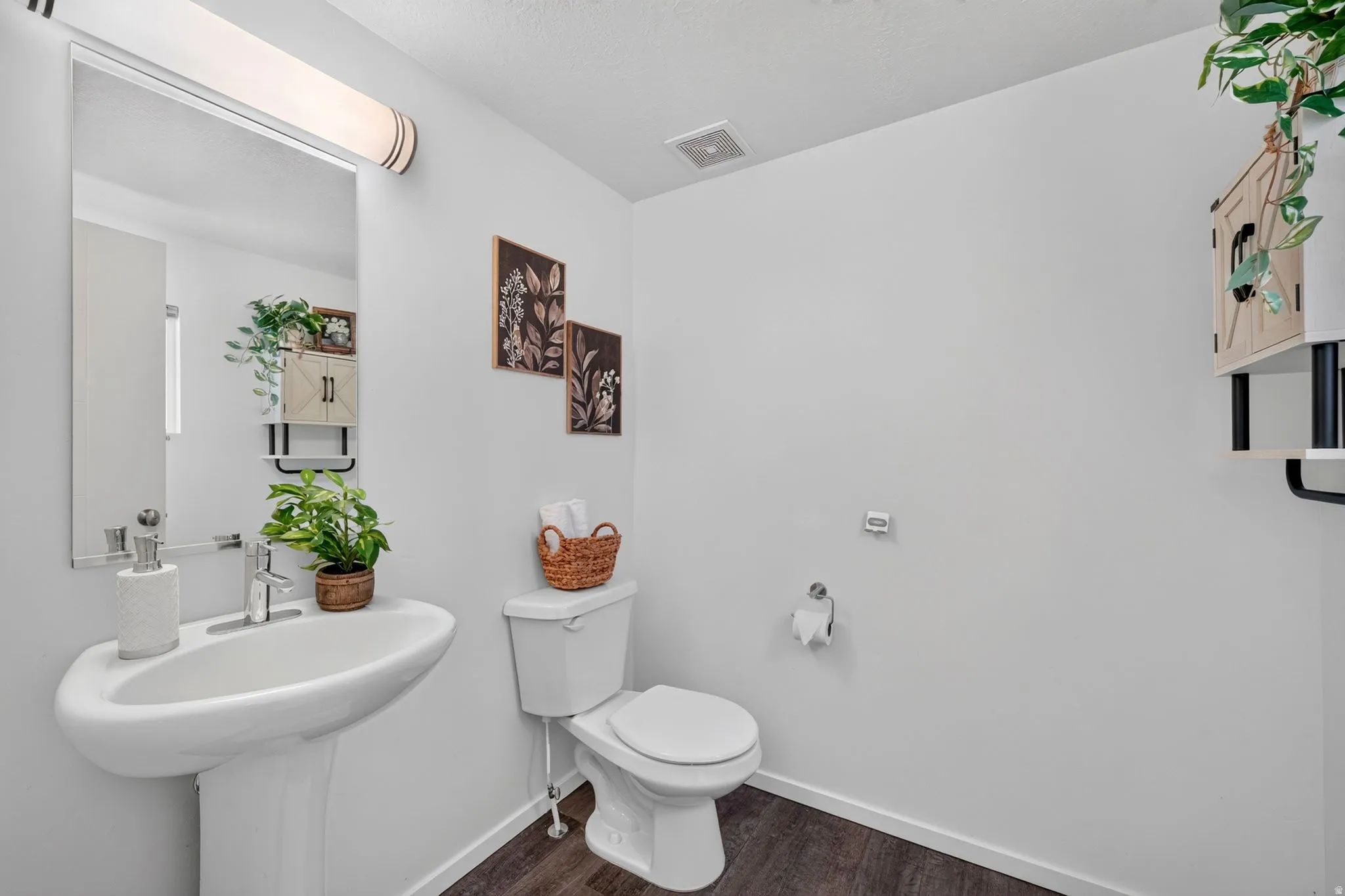 Pedestal sink with chrome faucet and rectangular mirror