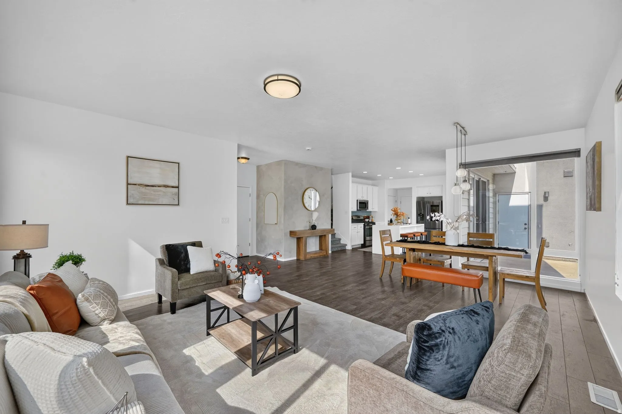 Open-concept living space featuring wood-finish flooring and recessed lighting