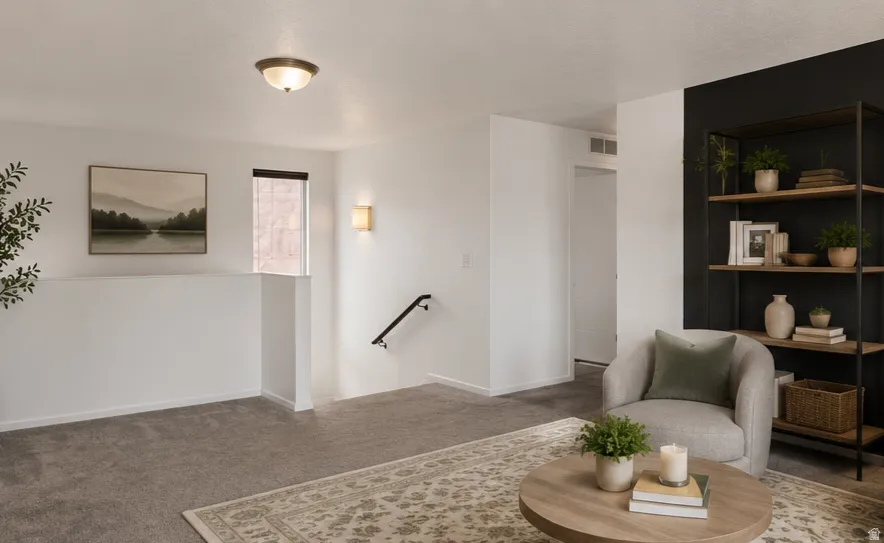 Virtually staged loft area featuring textured gray carpeting.