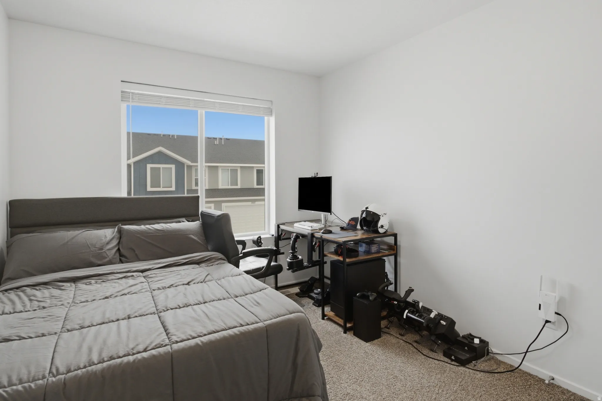 Room featuring a large window, neutral wall paint, and textured carpeting