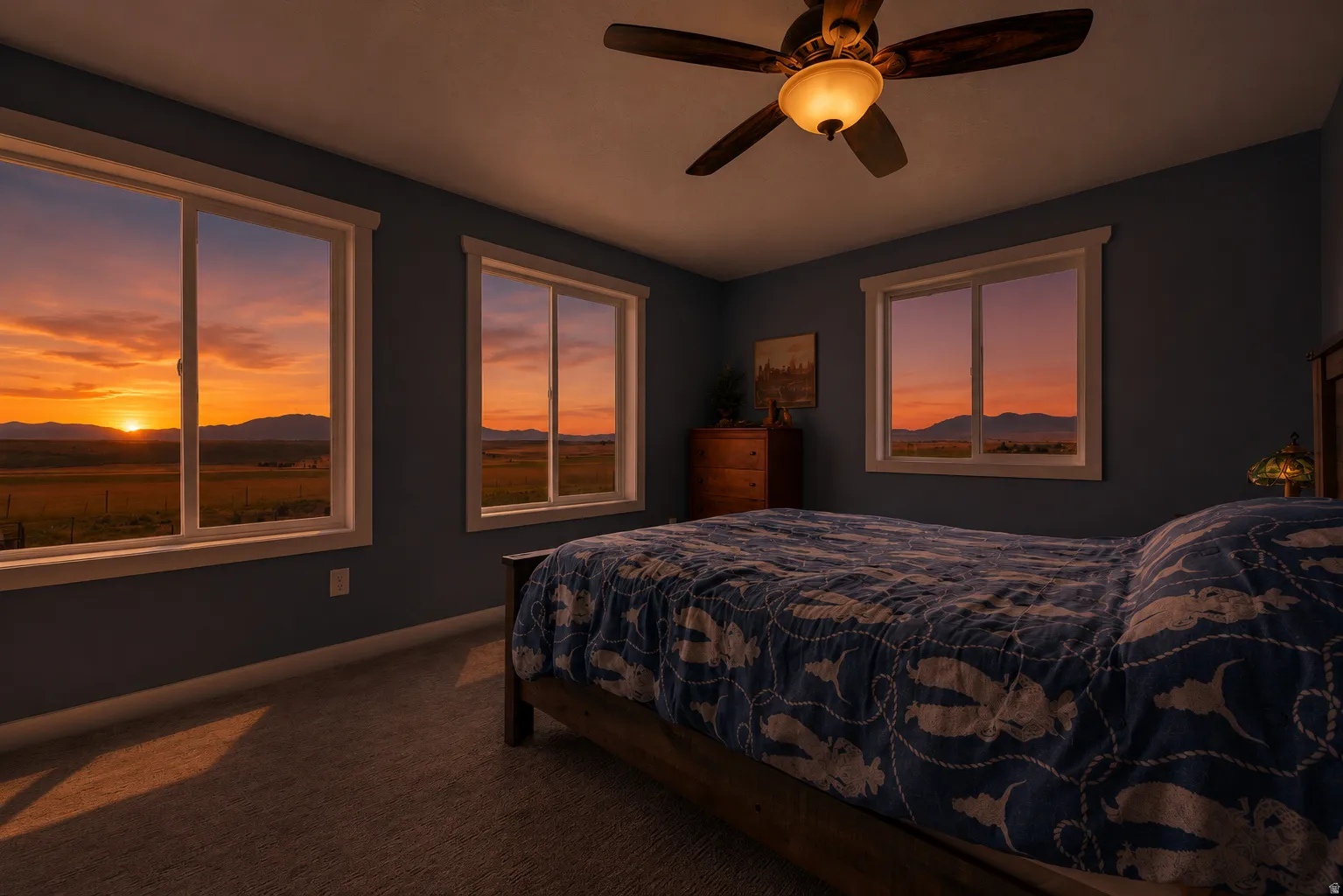 Bedroom featuring multiple windows, a ceiling fan with integrated lighting, and wall-to-wall carpeting