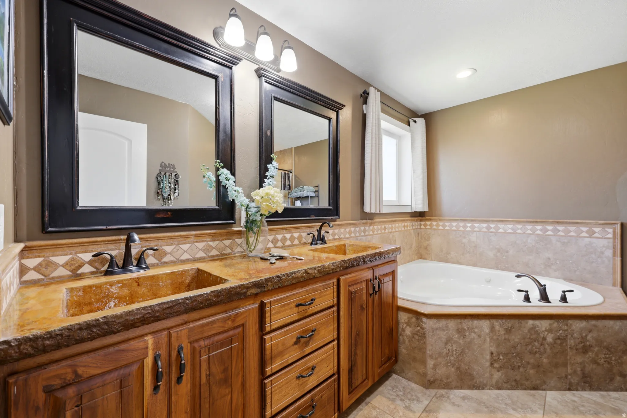 Double vanity with integrated sinks and custom wood cabinetry