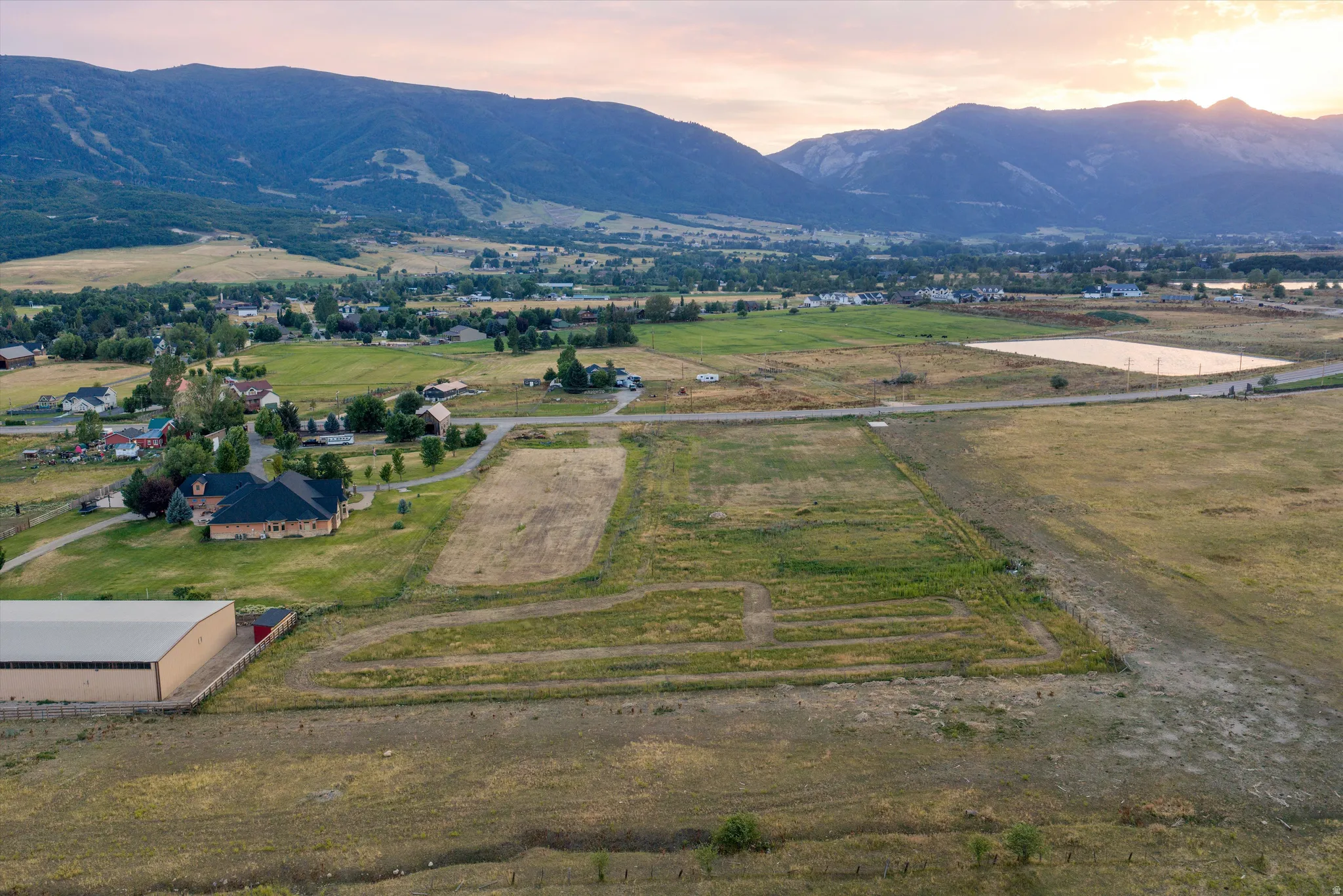Expansive land parcel featuring open fields and distant mountain ranges