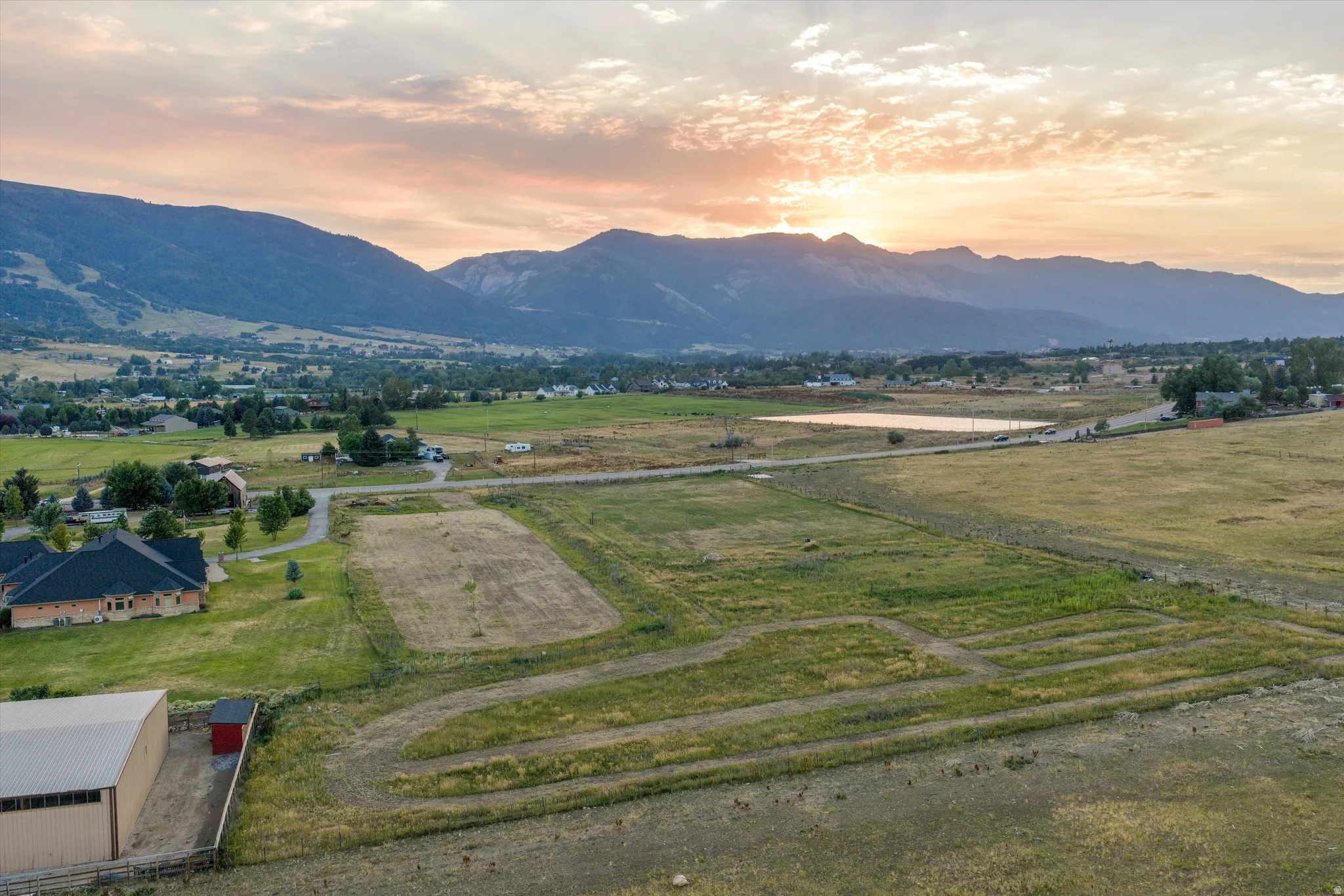 Expansive land parcel featuring open fields and distant mountain ranges
