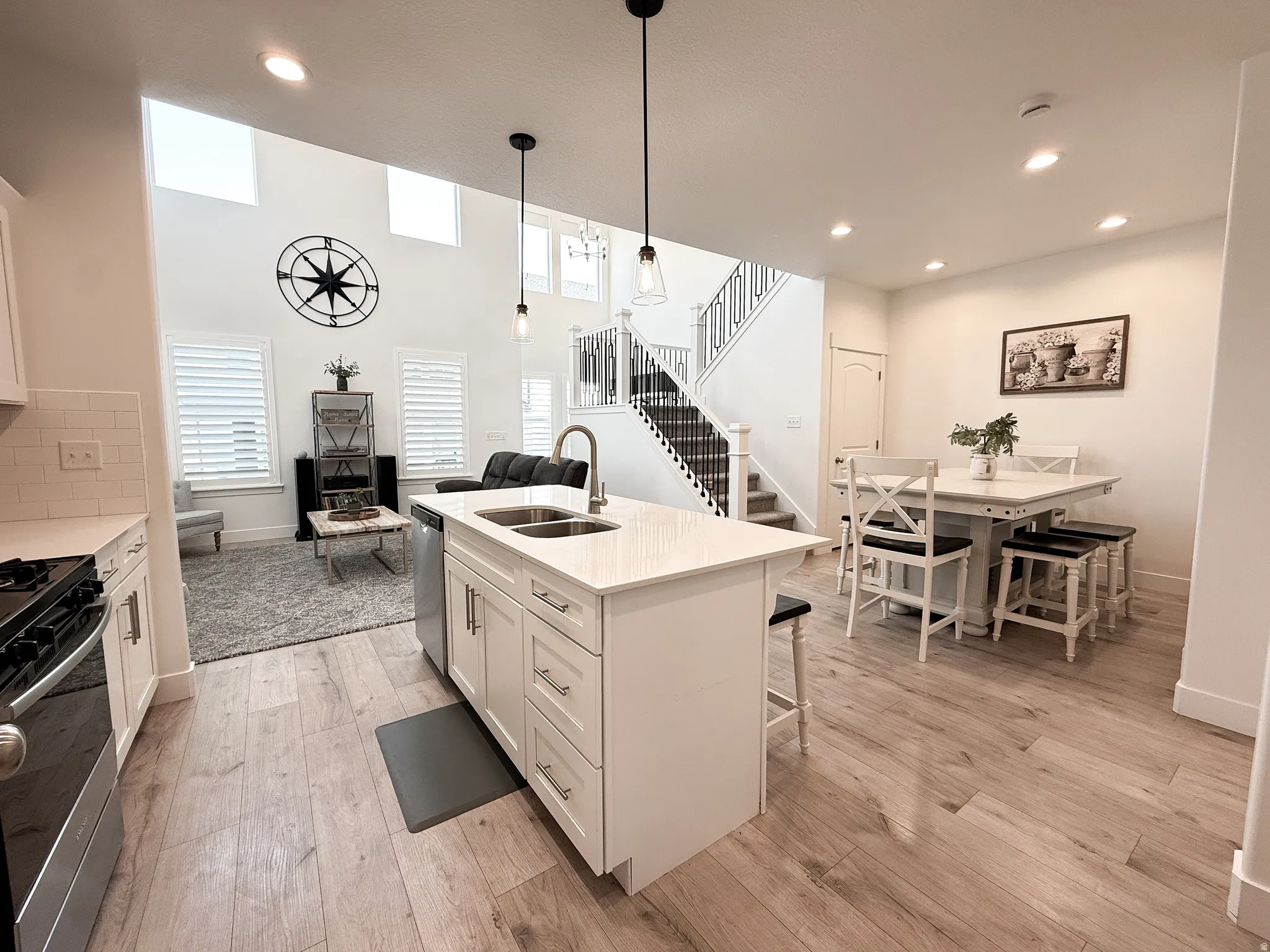 Open-concept living area featuring light wood-finish flooring throughout