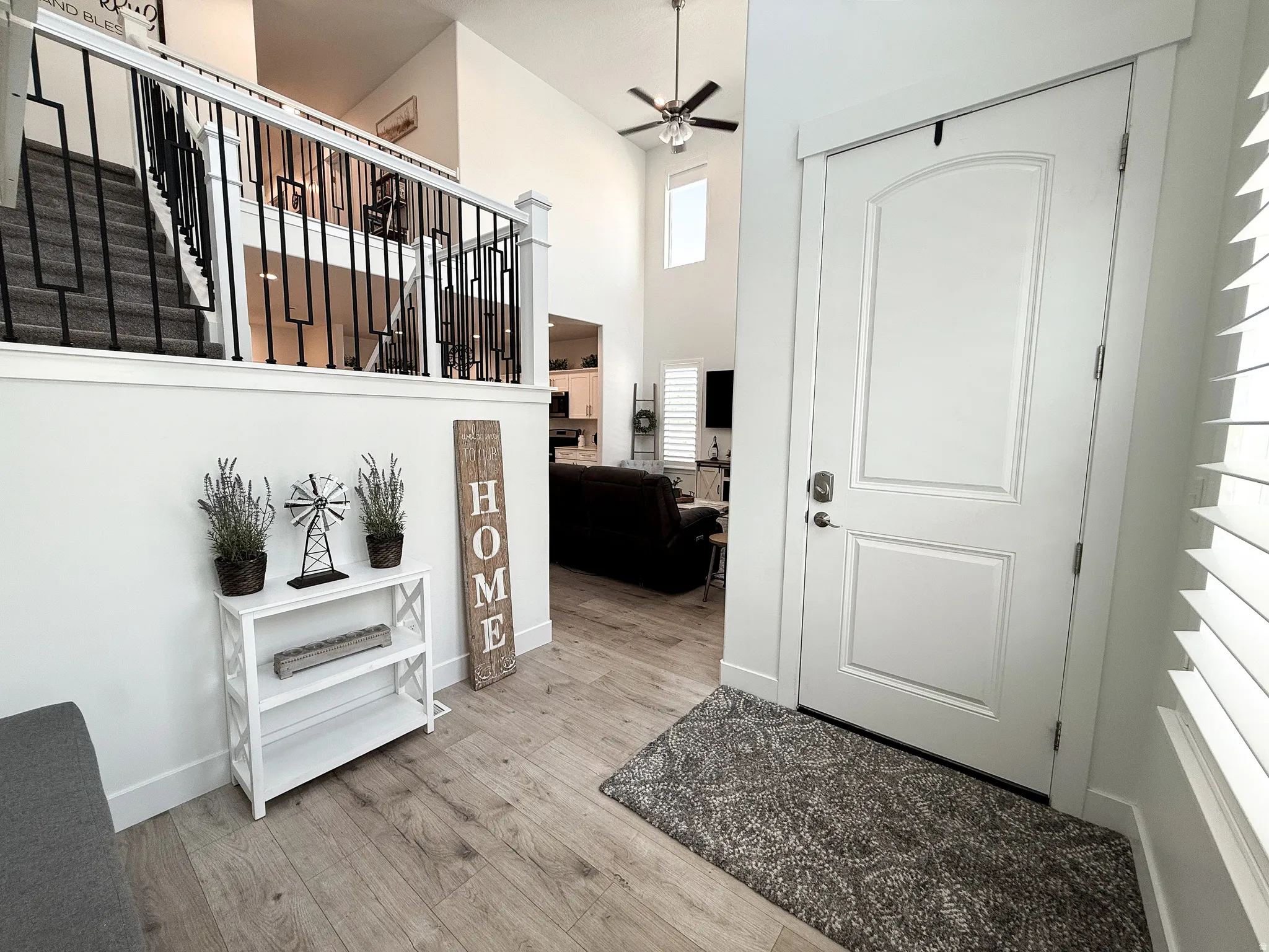 Foyer entryway featuring light wood-finish flooring and a white paneled door