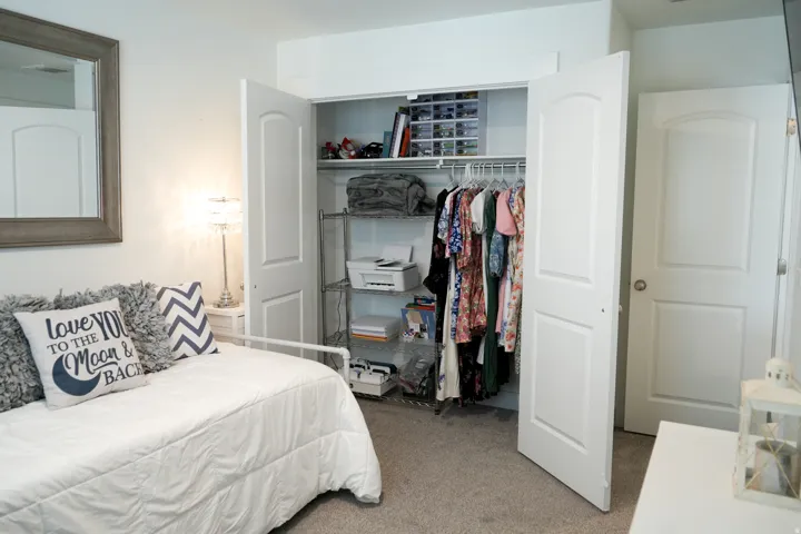 Bedroom with neutral carpet flooring