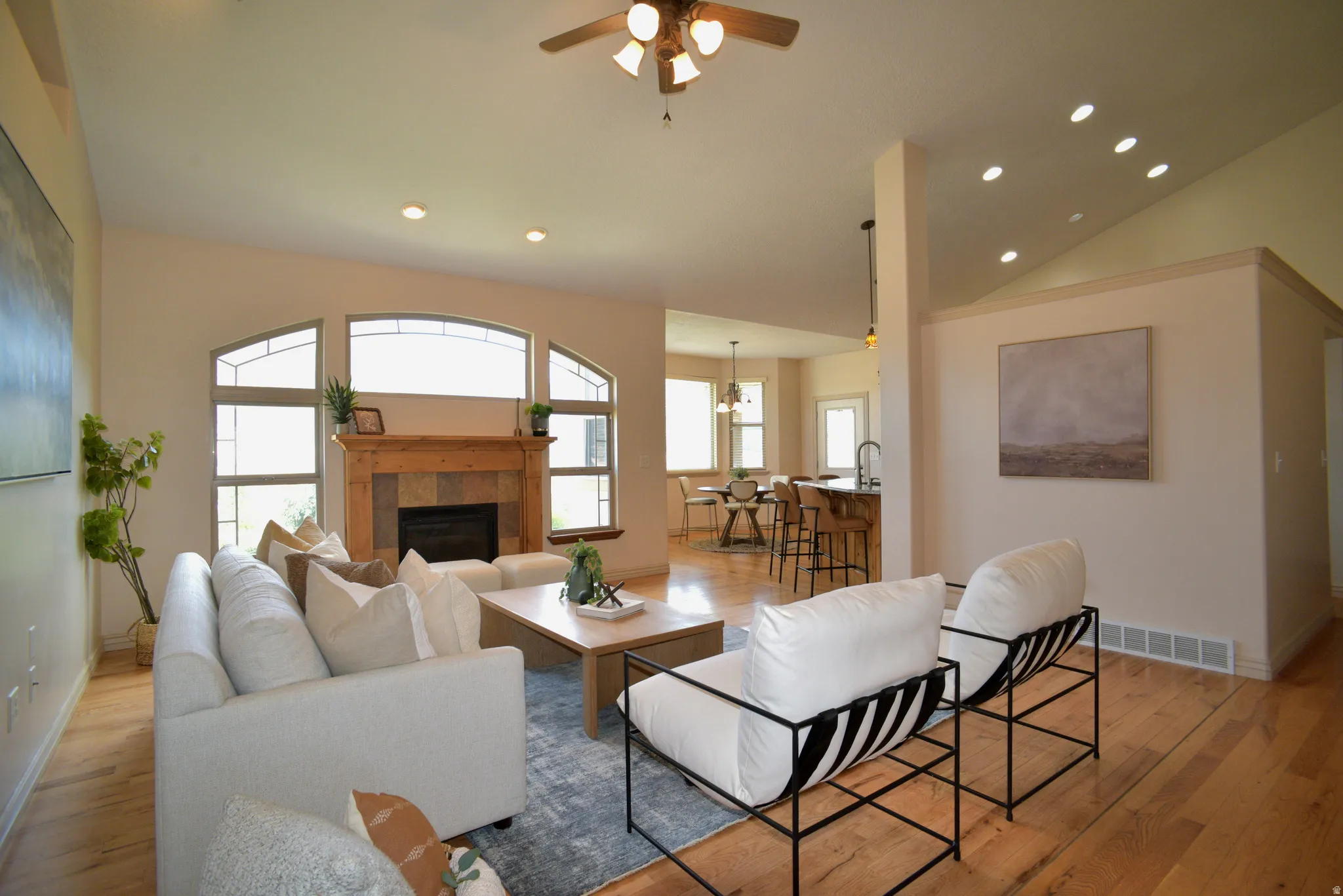LARGE VAULTED GREAT ROOM WITH GAS FIREPLACE AND BEAUTIFUL VIEWS FROM THE DECORATIVE WINDOWS!