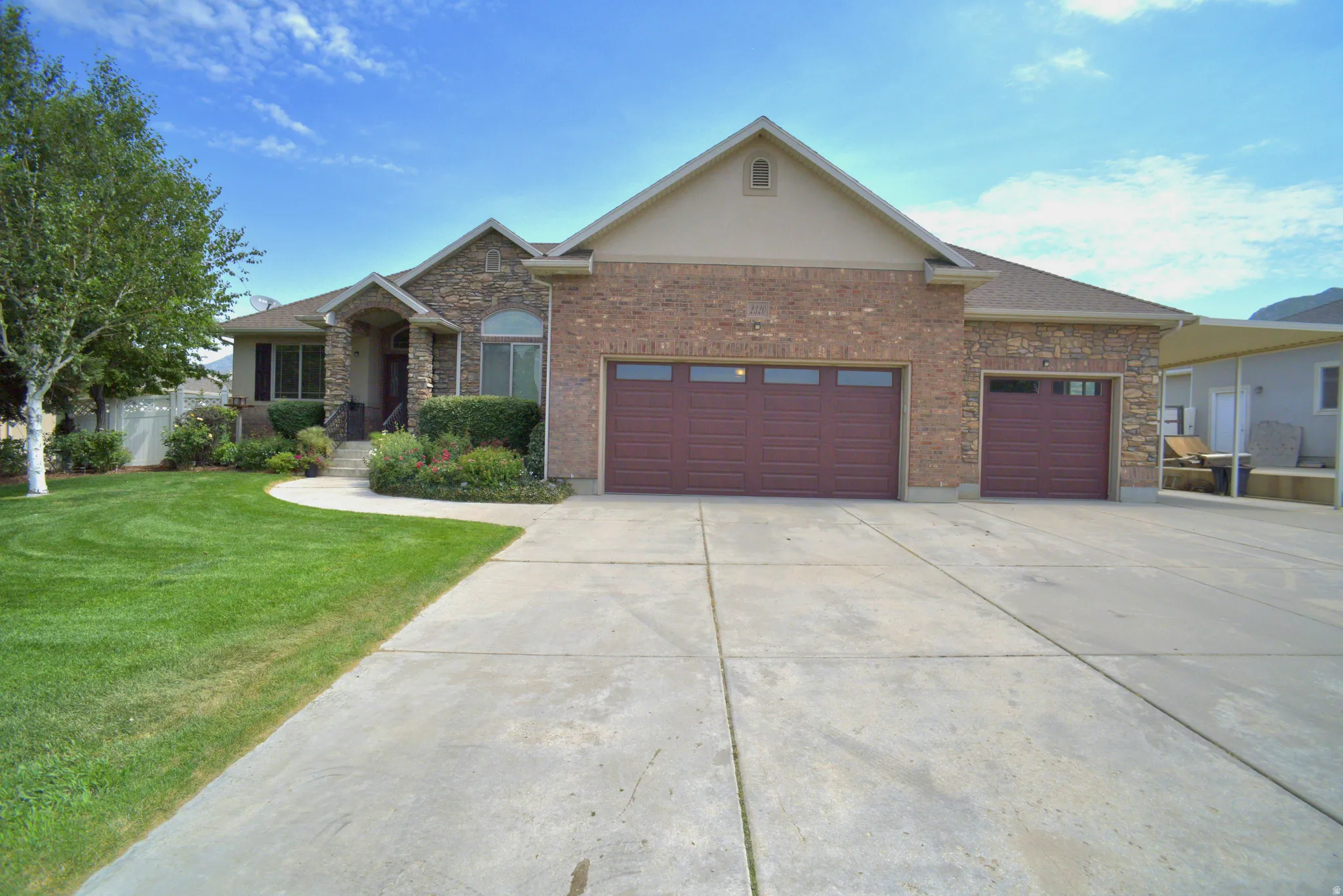 GARAGE IS EXTRA HIGH, EXTRA WIDE AND EXTRA DEEP WITH WORK BENCH INCLUDED