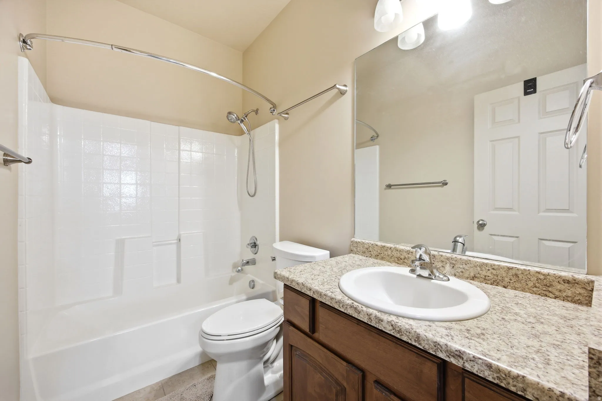 Full bathroom featuring a white tub and shower combination with a curved shower rod