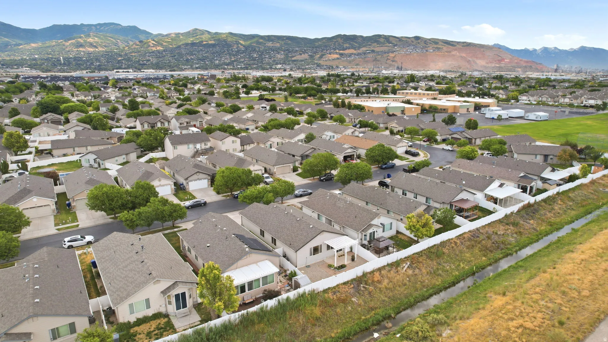 Expansive residential neighborhood featuring single-story homes with attached garages and gabled roofs