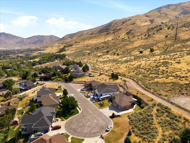 Aerial perspective showcasing a residential cul-de-sac with surrounding mountainous terrain