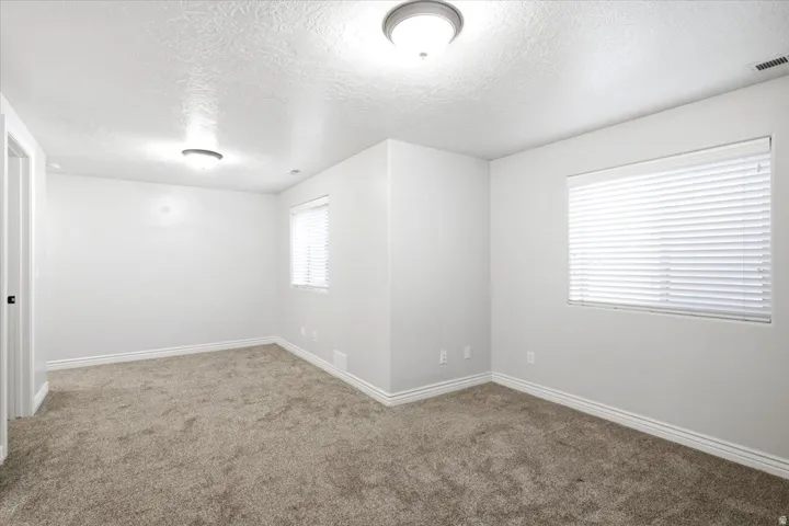 Room featuring neutral wall finishes and a textured ceiling