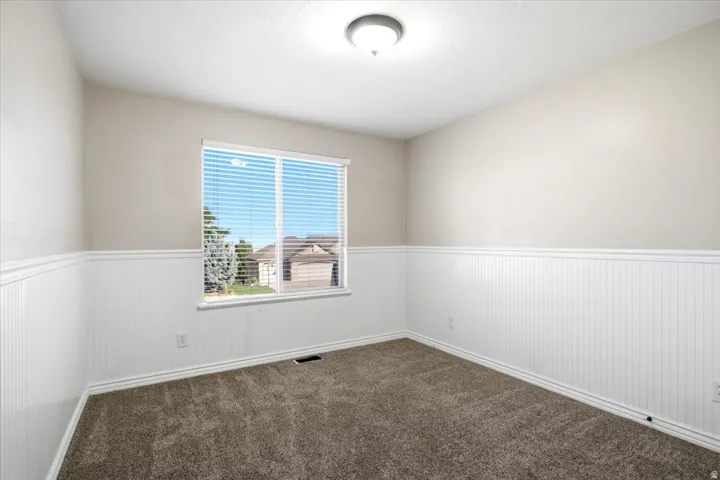 Neutral tone walls featuring wainscoting and coordinating trim